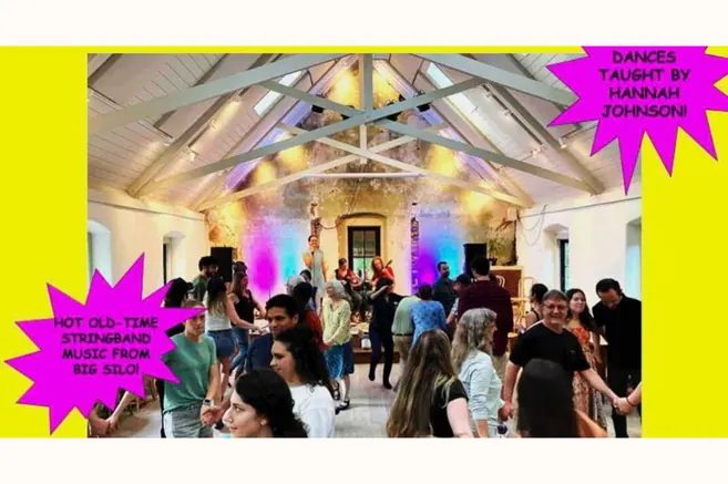 A crowd dancing under the trusses of the Potter's Craft Cider hall