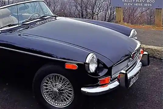 A black vintage MG roadster parked at Afton Mountain Vineyards